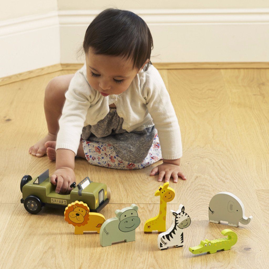 little-girl-playing-with-orange-tree-toys-safari-playset